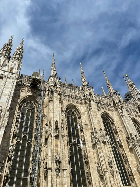 tall gothic cathedral building with several stone towers and windows