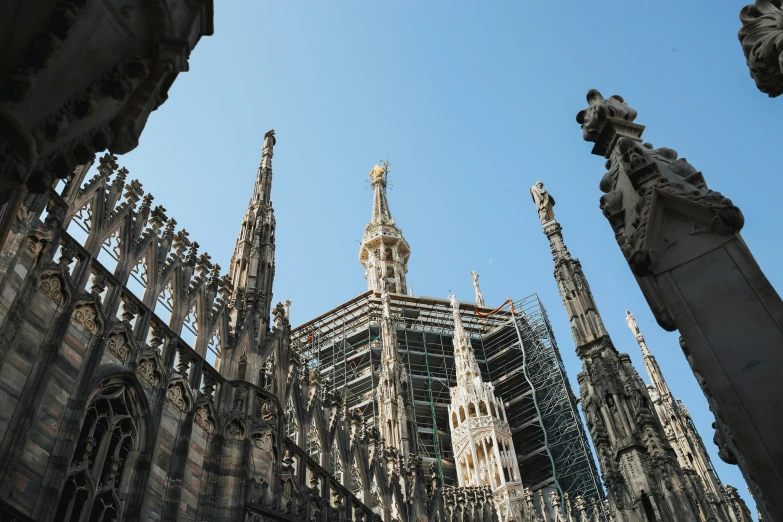 a clock tower sits above the ruins of the cathedral