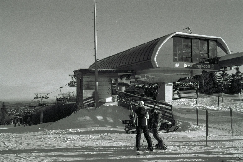 a skier posing on a mountain top with his skis out