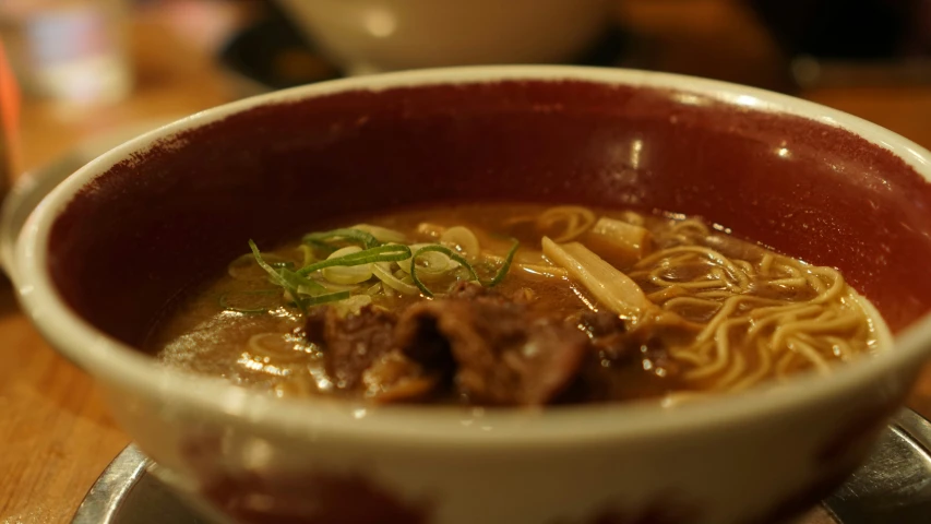 a bowl filled with noodles and meat