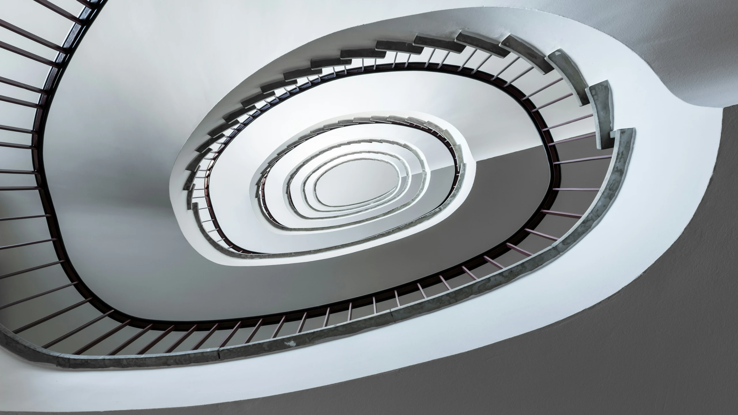 the inside of a spiral staircase that is in a building