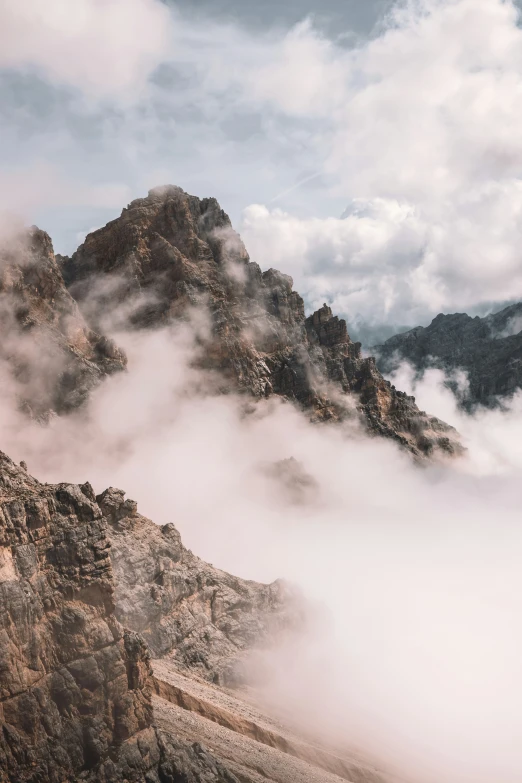 low lying clouds over a rocky mountain range