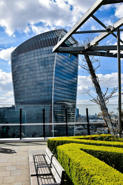 some buildings in a courtyard with trees and bushes