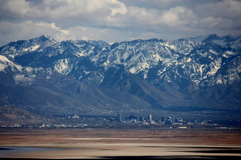 a large mountain range in front of a city