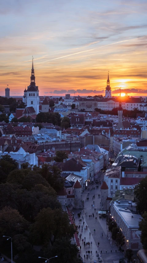 a sunset over the city is lit by some buildings