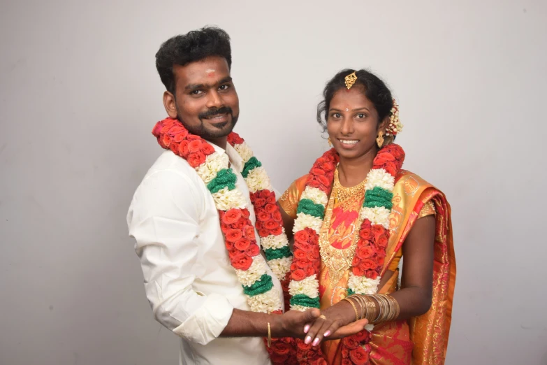 a newly wed couple in traditional indian garb