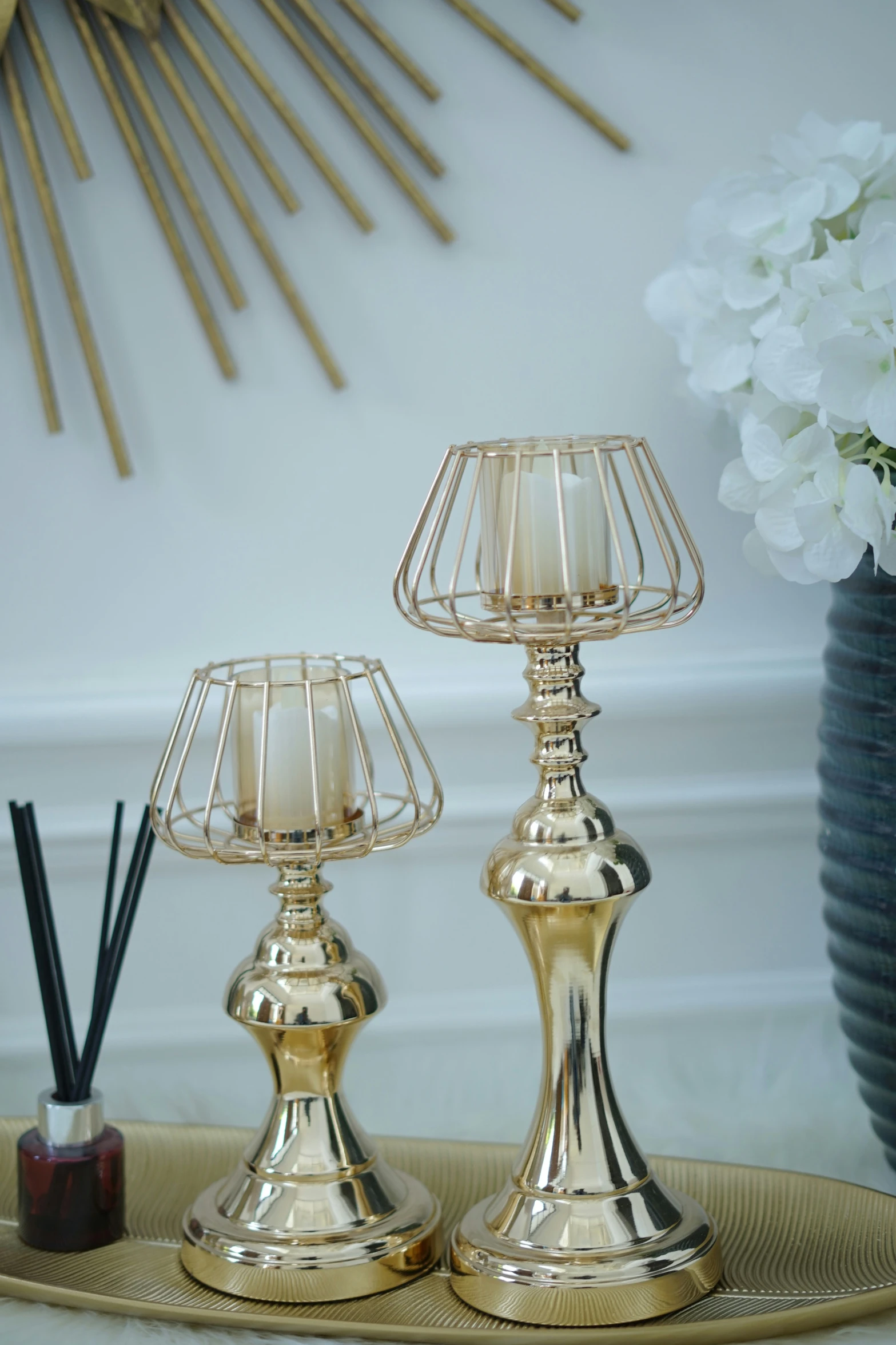 a couple of gold lamps sitting on top of a table