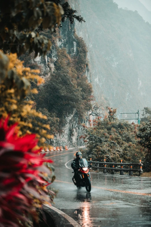 a person riding a motorcycle in the rain