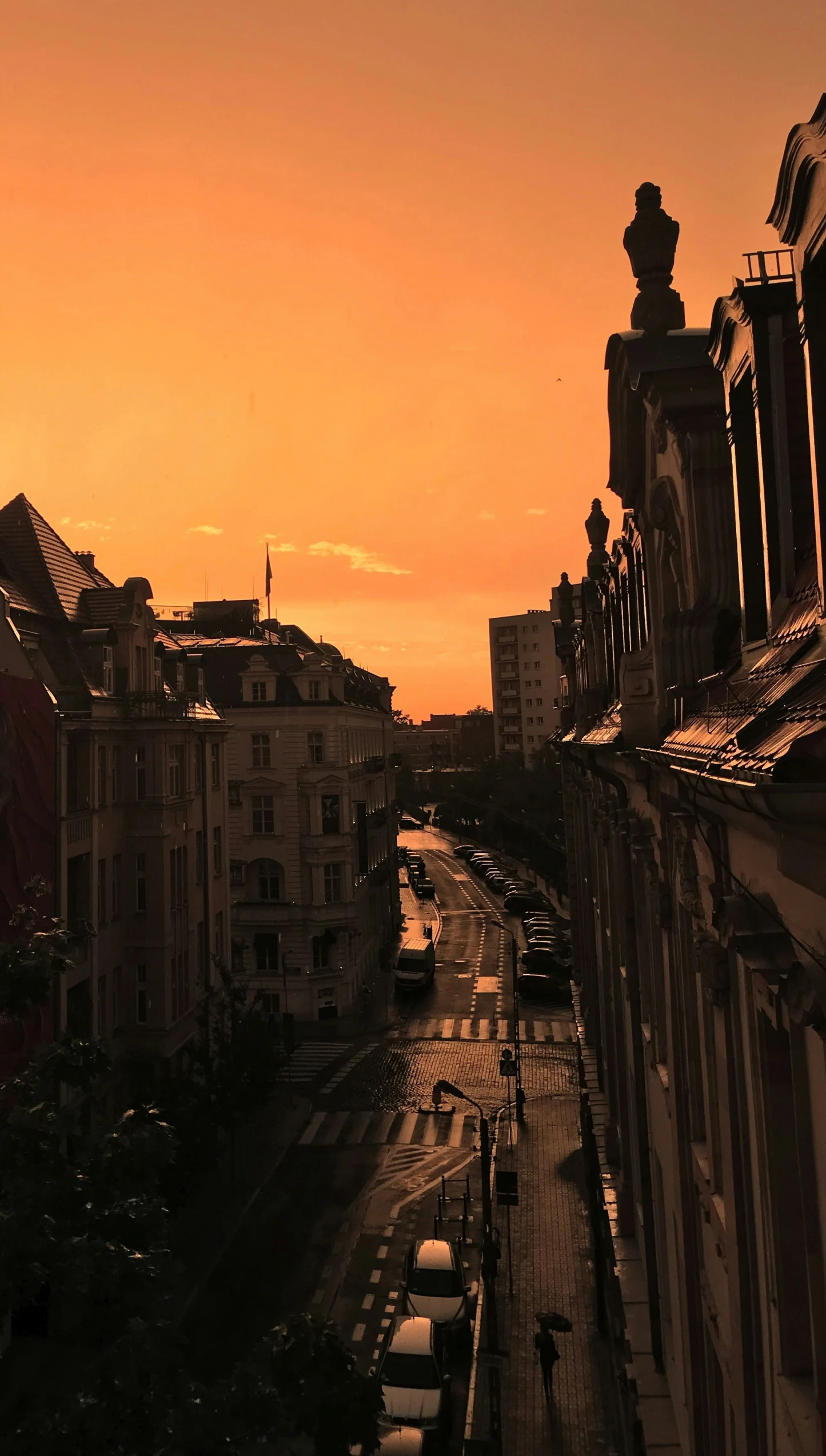 a view of some very big buildings and street at sunset