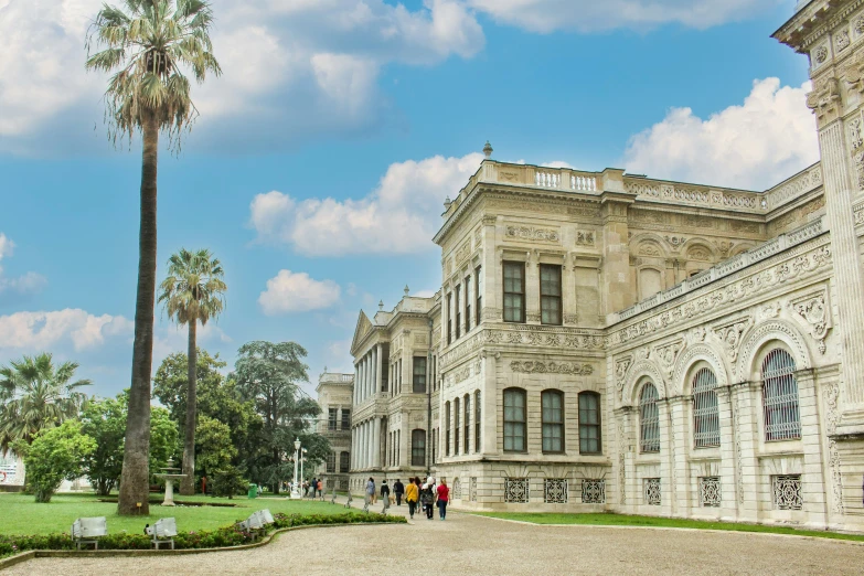 a long building with people walking on the ground