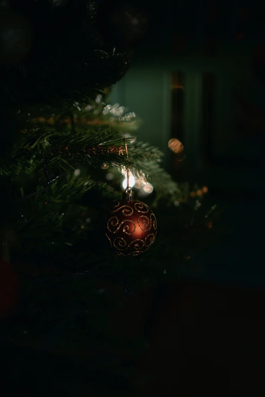 a christmas tree with an ornament hanging from it