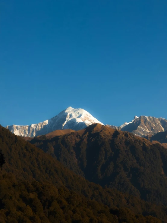 mountain landscape with snow - capped peaks in evening