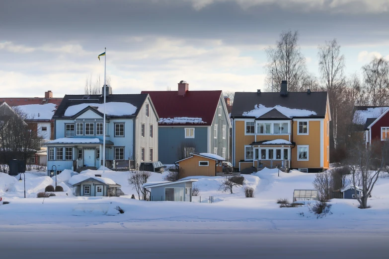 a row of houses are covered in snow