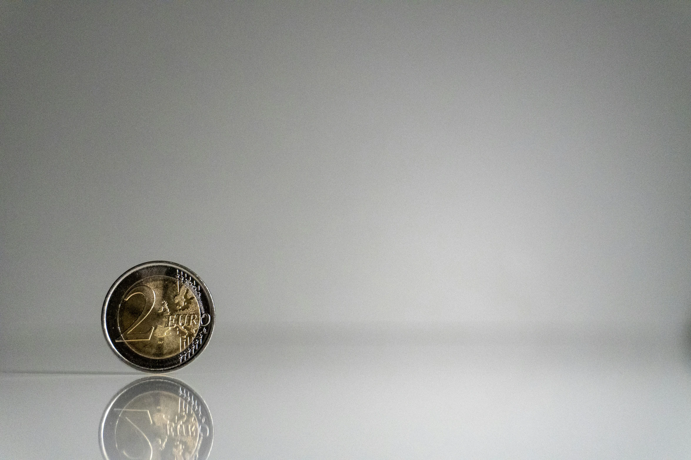 a close up of a silver plate on a white table