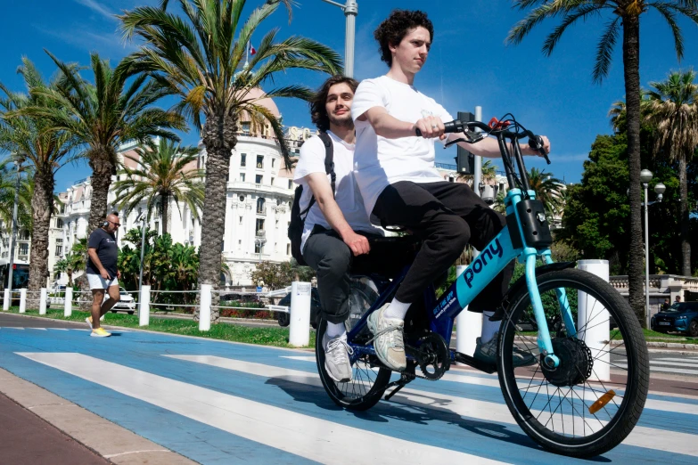 a woman riding a bike with a man sitting on it