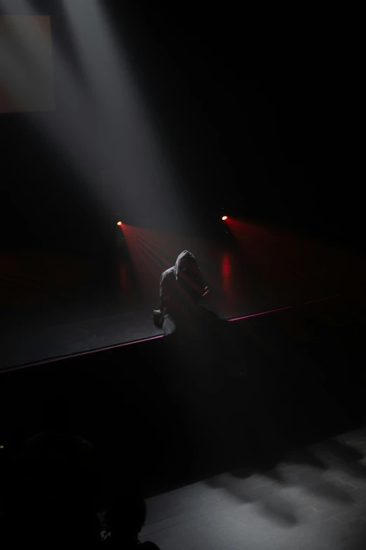 people walking down a stage at night with lights