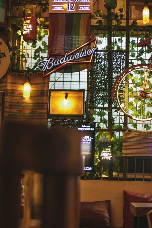 the front window and sign to budweiser's is decorated with ivy