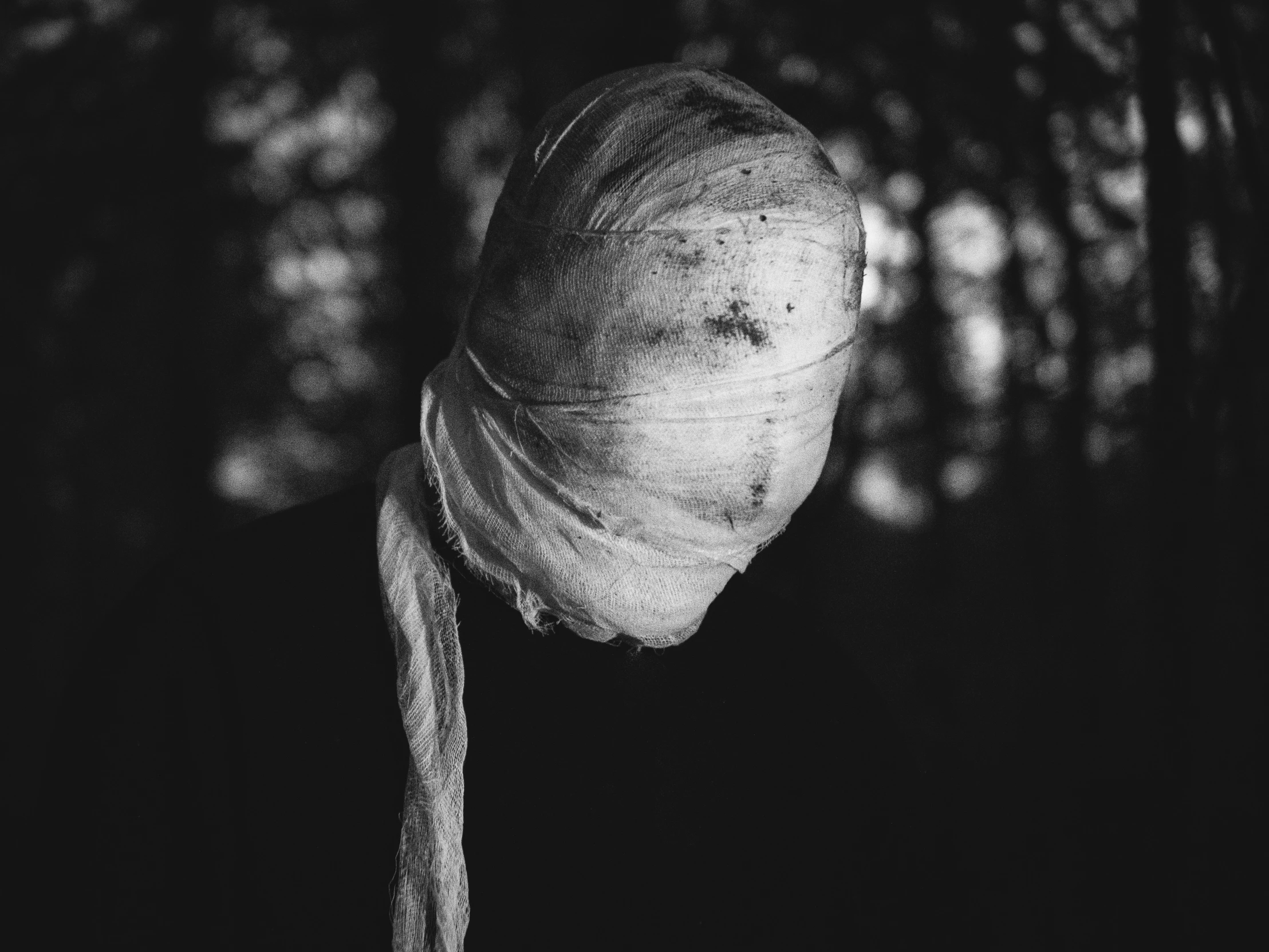 a woman standing in front of some trees