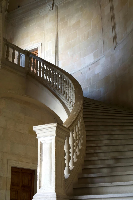 stairs are positioned under the large curved ceiling