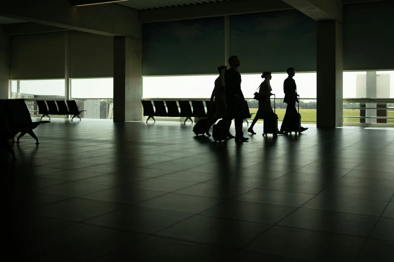 people walking along a sidewalk with luggage