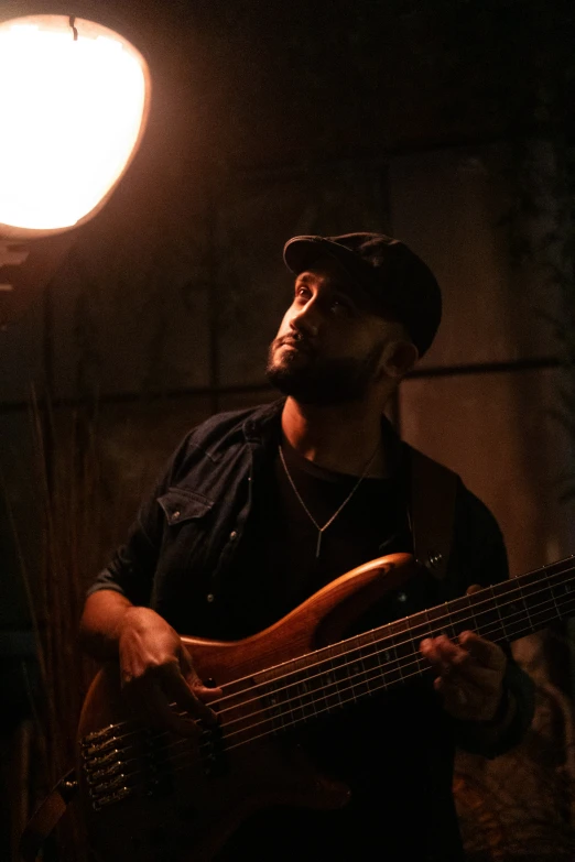 a man is playing guitar in the dark