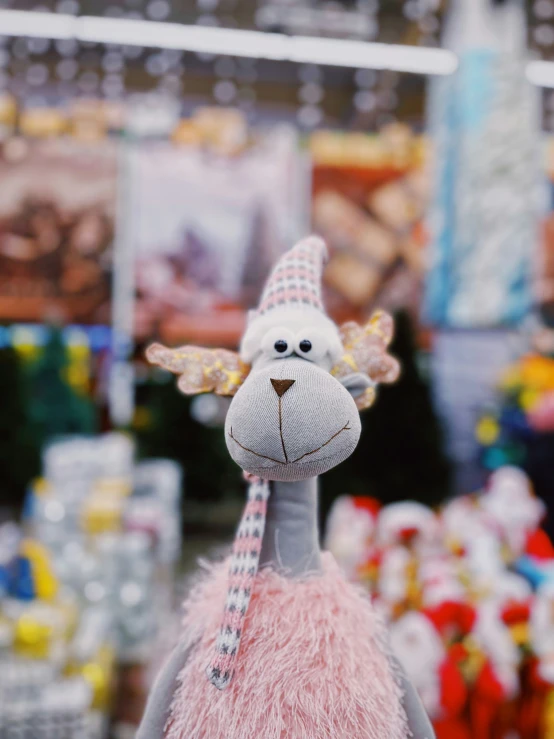 a hand - made doll with large eyes in a toy store