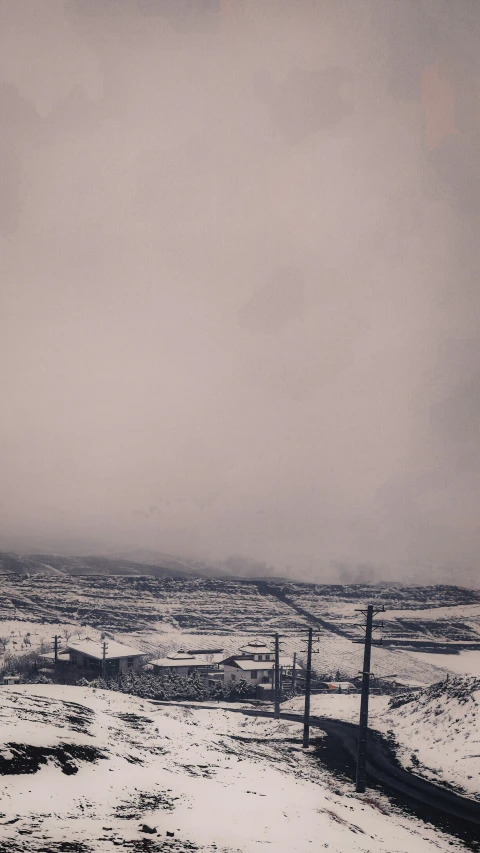 a single snowboard is parked at the top of a hill