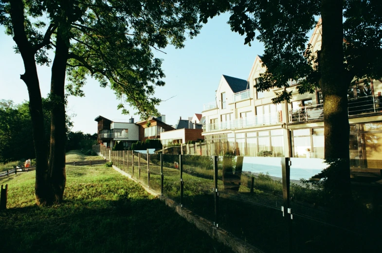 a po taken through a fence looking at a large building