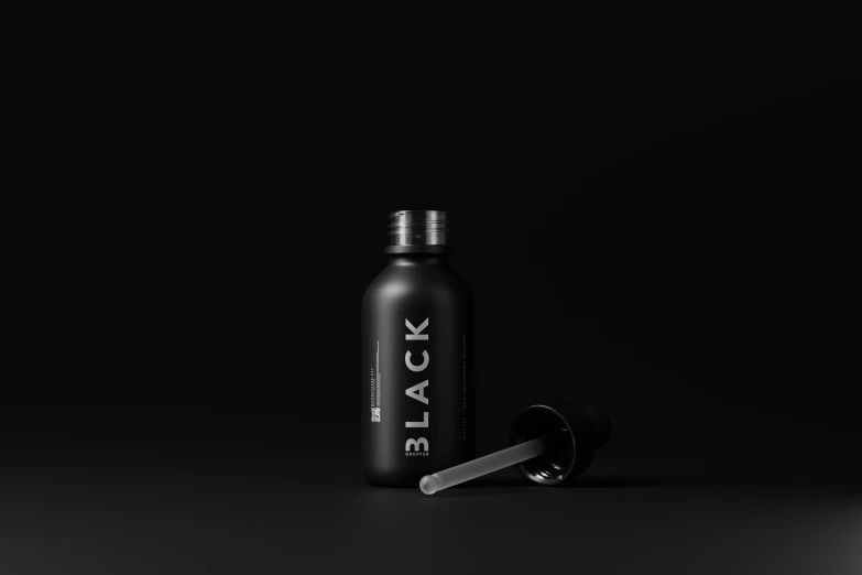 a black bottle and brush sitting next to each other