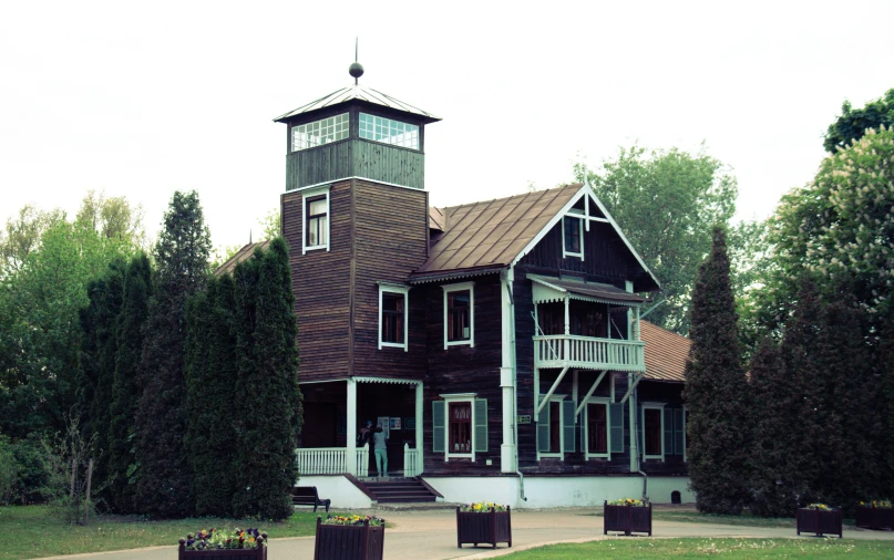 a big brown building with a clock on the top