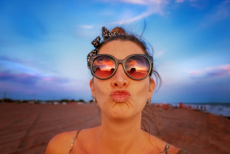 a woman making a silly face with her sunglasses on