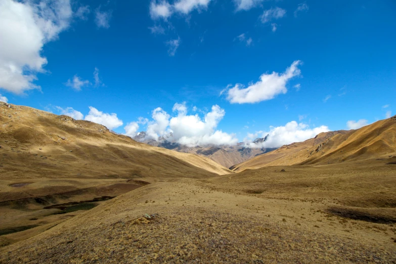 a mountain landscape, with clouds floating in the sky