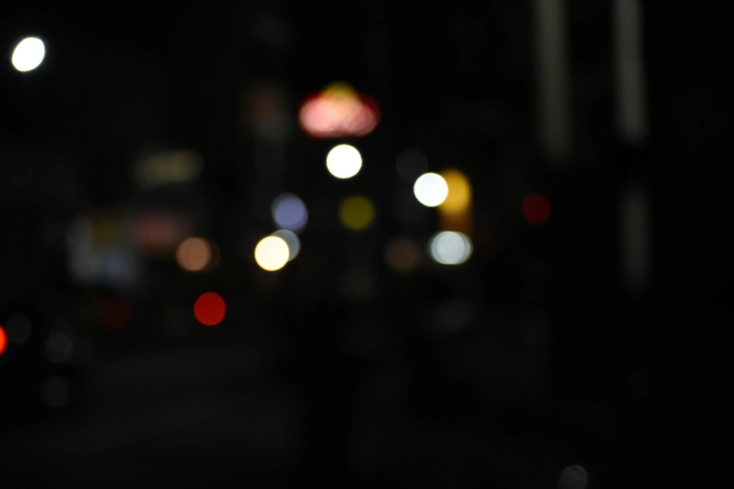 blurry street light at night with many car lights