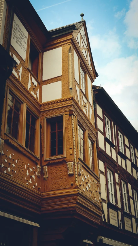 a row of two story building sitting on the corner of a street