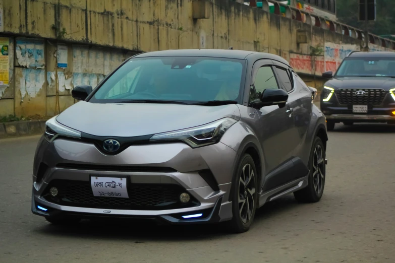 the toyota c - hr concept driving down a city street
