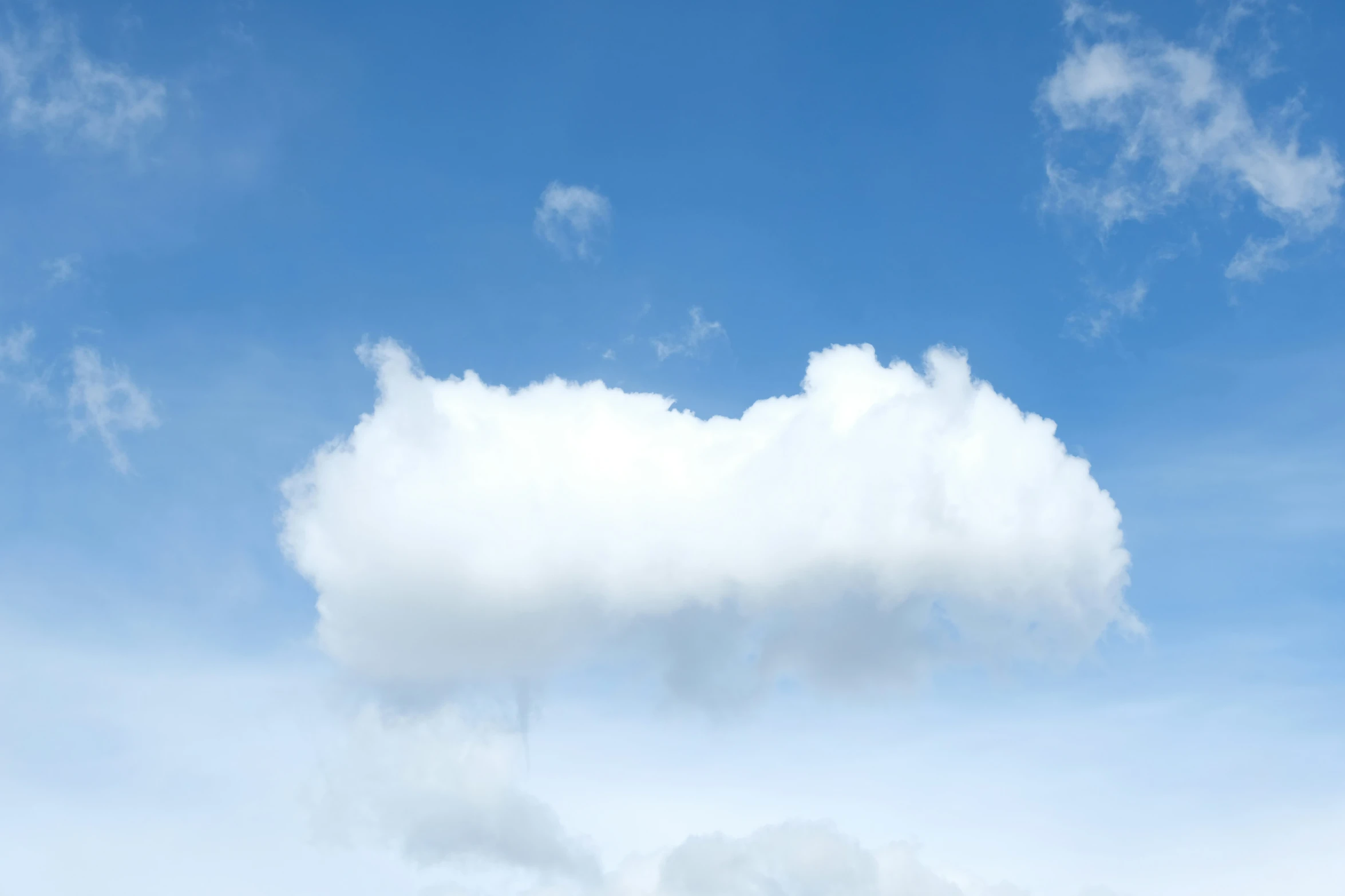 a tall white cloud in a blue sky