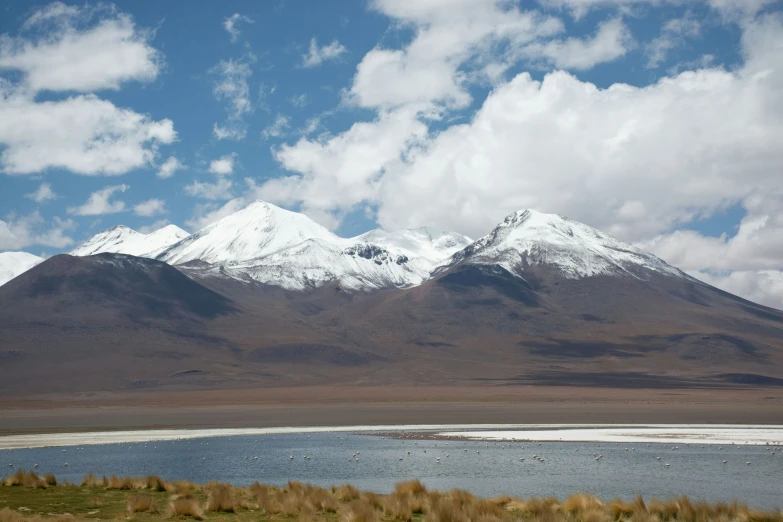 a large mountain sitting next to a lake