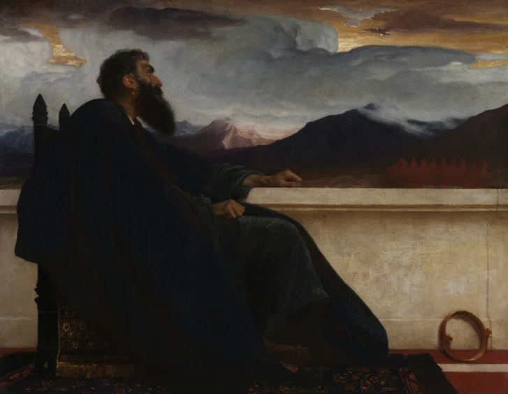 a man with a beard sitting on a bench in a room