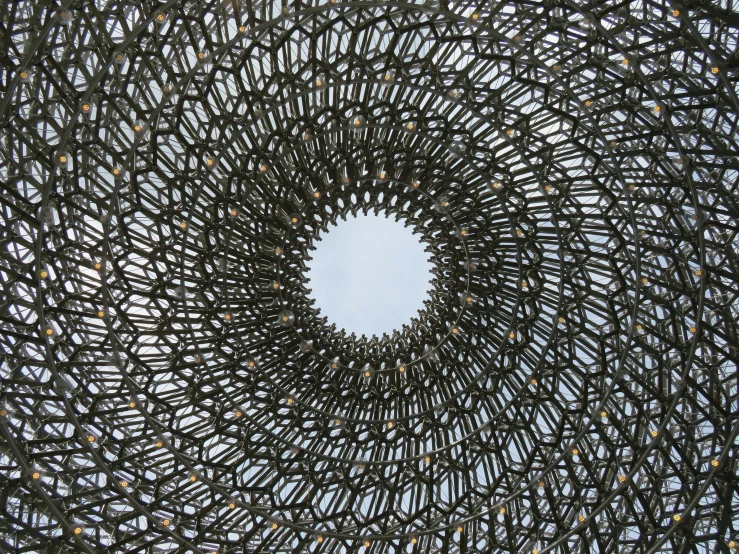 a view from below of a sculpture with holes