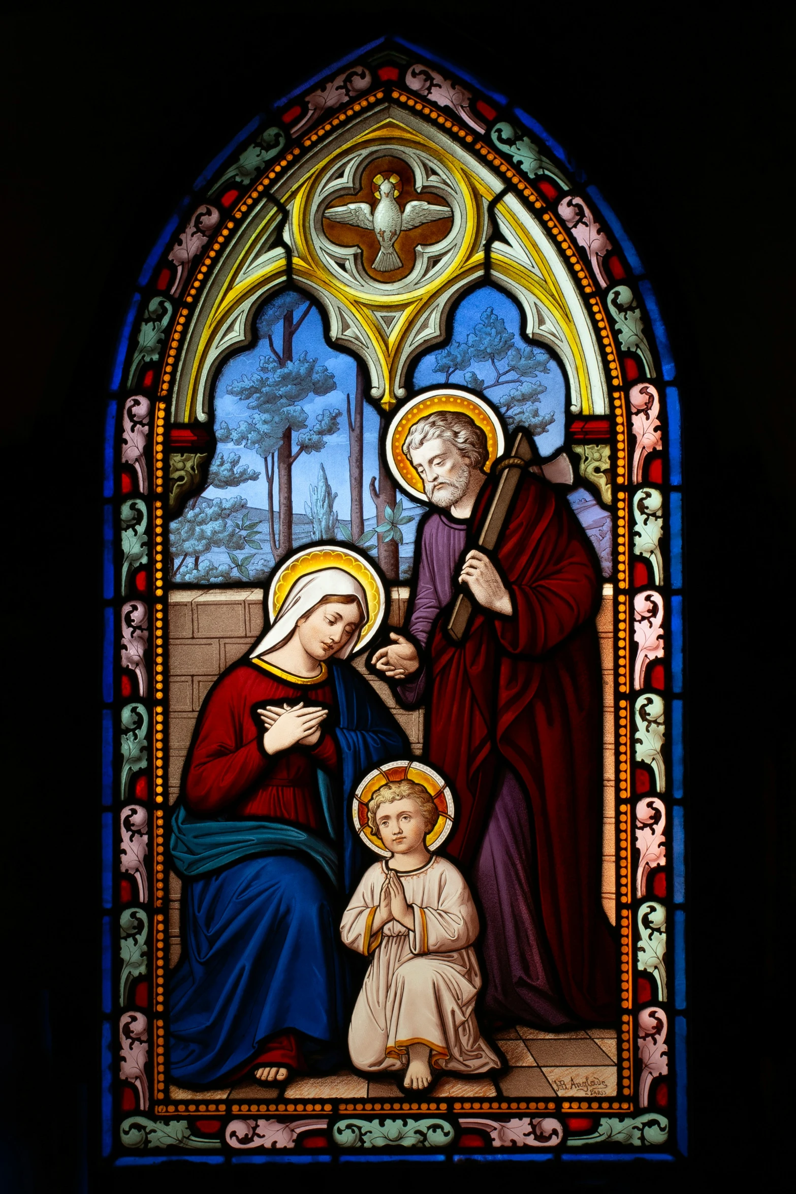 a stained glass window with the image of jesus, mary and baby jesus