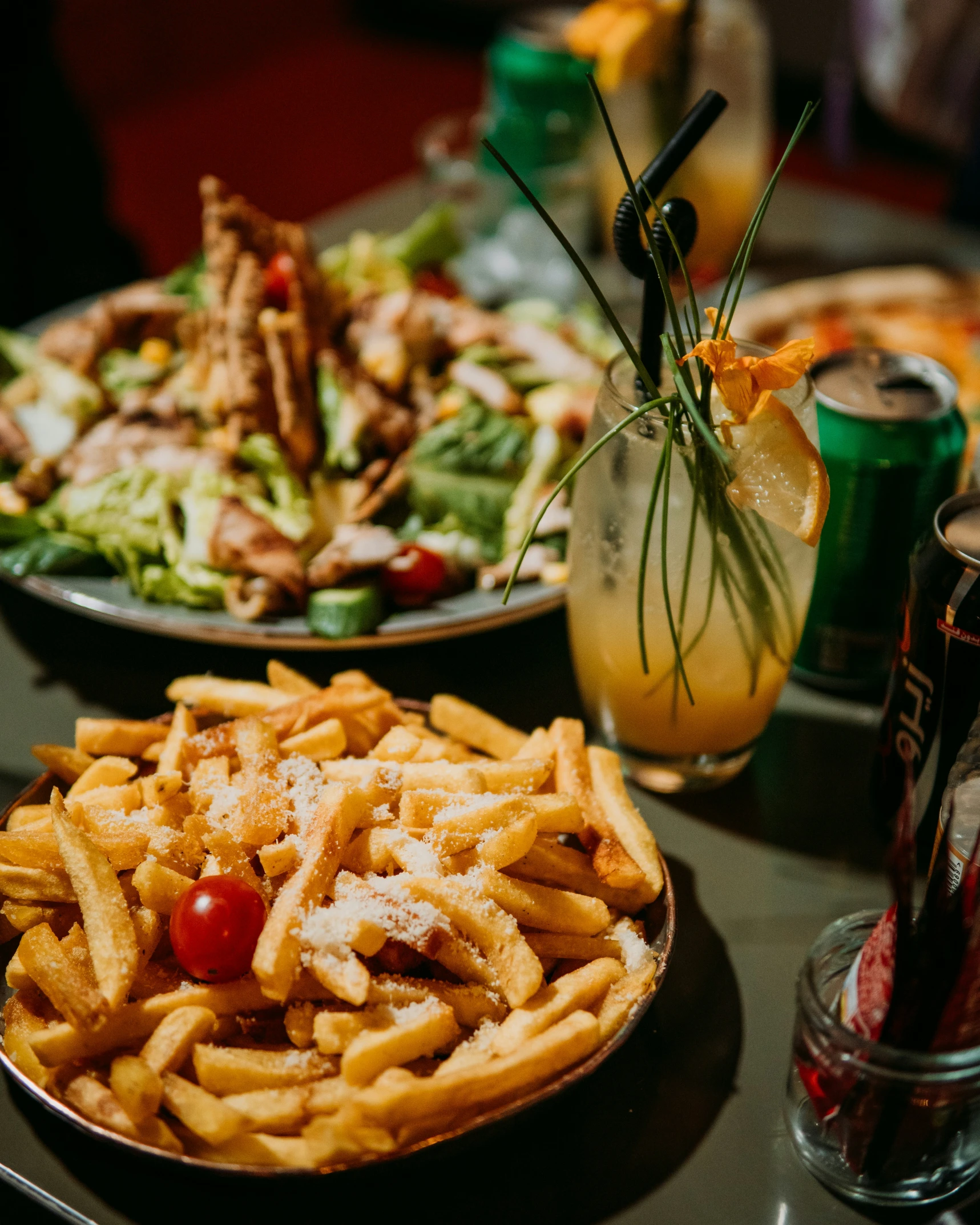 a table full of plates of food and drinks