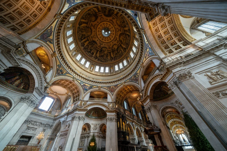 the ceiling is lined with gold and white arches