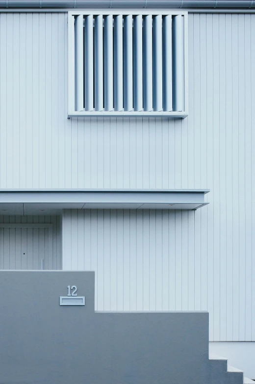 a modern steel building has windows and shutters