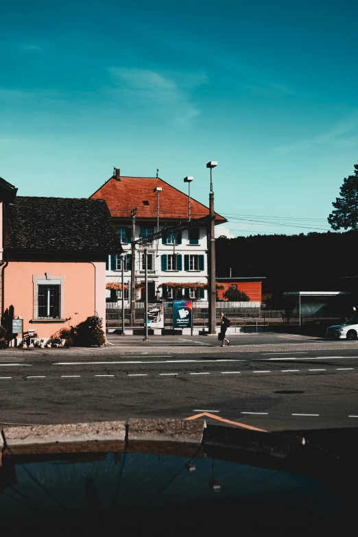 a building with a red roof next to water