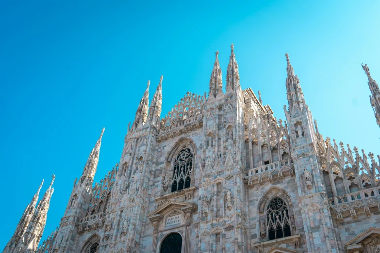 a tall cathedral with many windows and statues