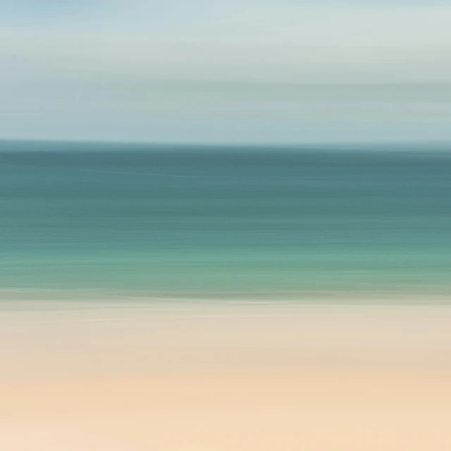 blurred, blue, gray and green ocean on the beach