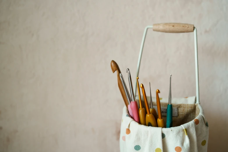 the organized bin is filled with colorful pens and needles