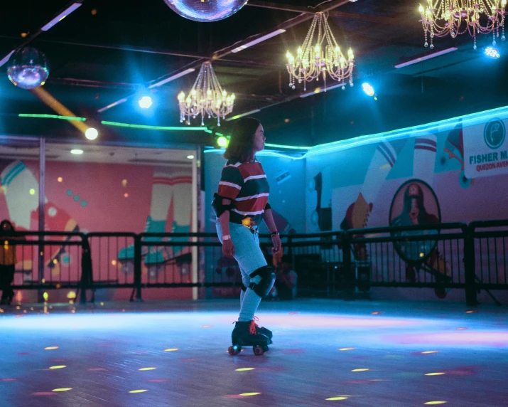 a young man is riding a skateboard on a blue floor