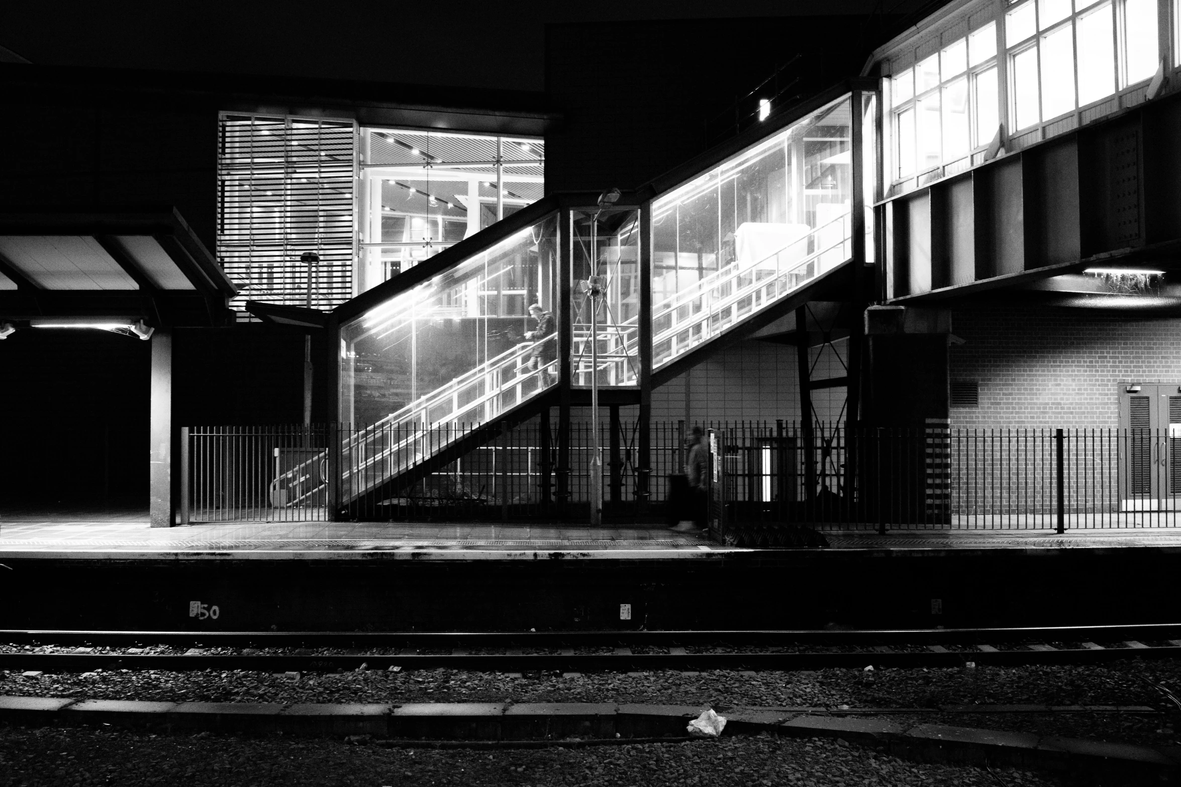 an empty train station at night lit up by street lights