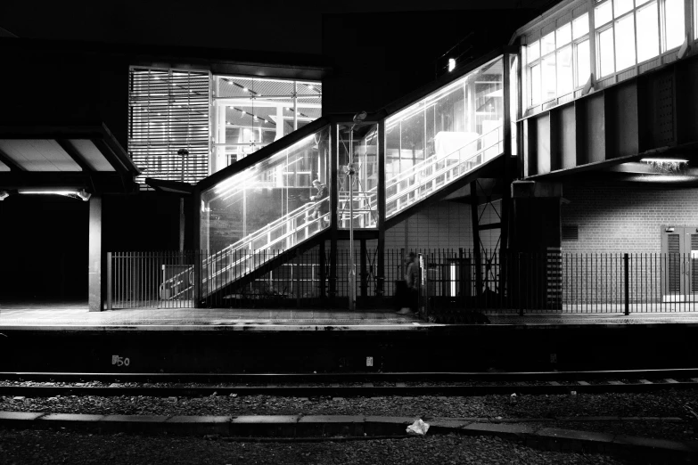 an empty train station at night lit up by street lights